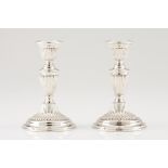 A pair of candle standsPortuguese silver Neoclassical fluted decoration and circular base Eagle
