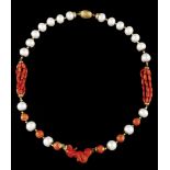 A necklaceCulture pearls alternating with gold and coral beads and central carved Angel figure