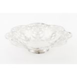 A footed fruit bowlPortuguese silver Plain centre of scalloped and pierced lip with stylised foliage