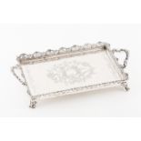 A traySilver Rectangular shaped of engraved foliage decoration with central blanc medallion