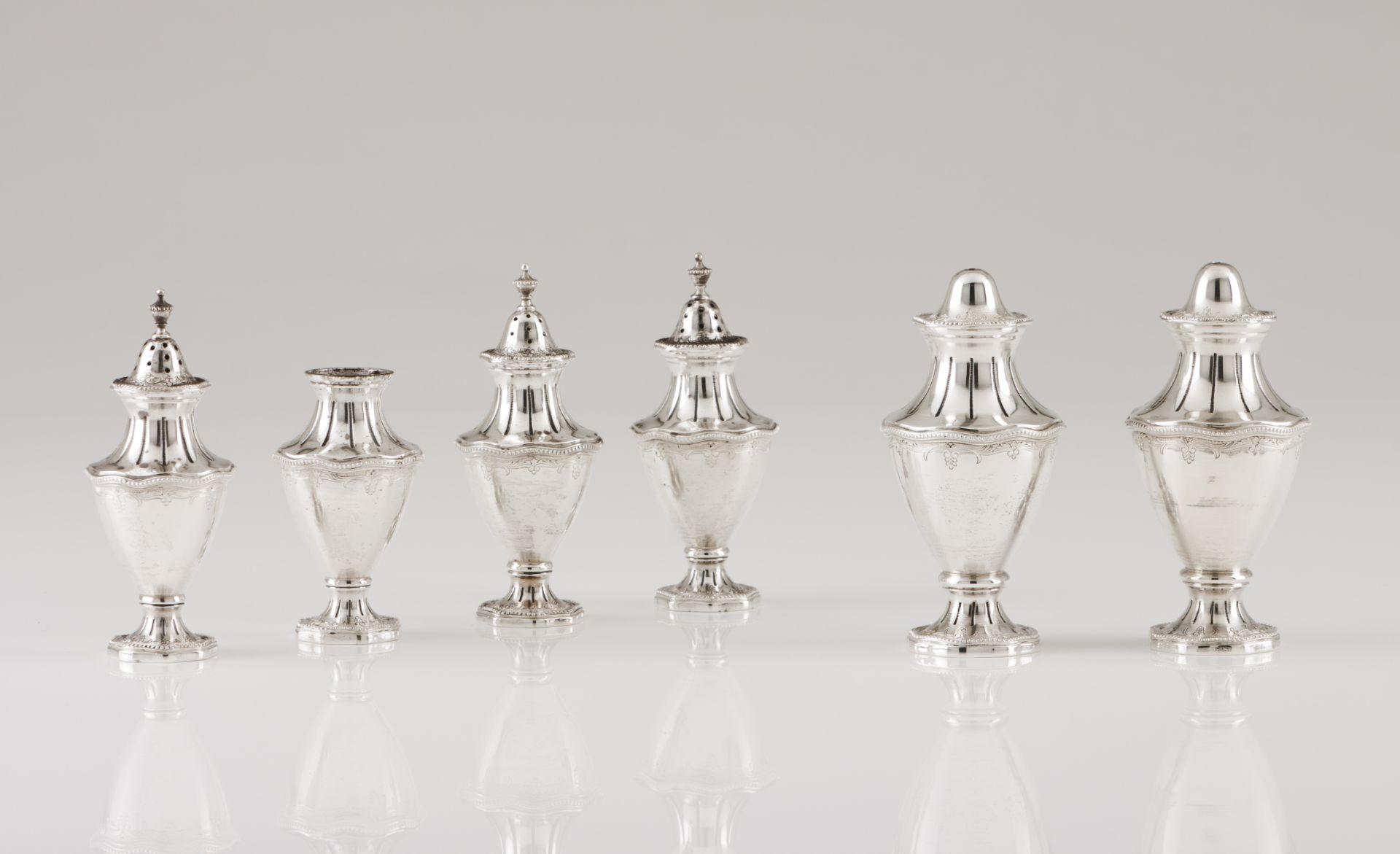 Two toothpick holders, two salt and two pepper shakersPortuguese silver Urn shaped of chiselled band