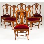 A set of six rocaille chairsWalnut Carved rails and aprons Pierced and scalloped backs, disc feet