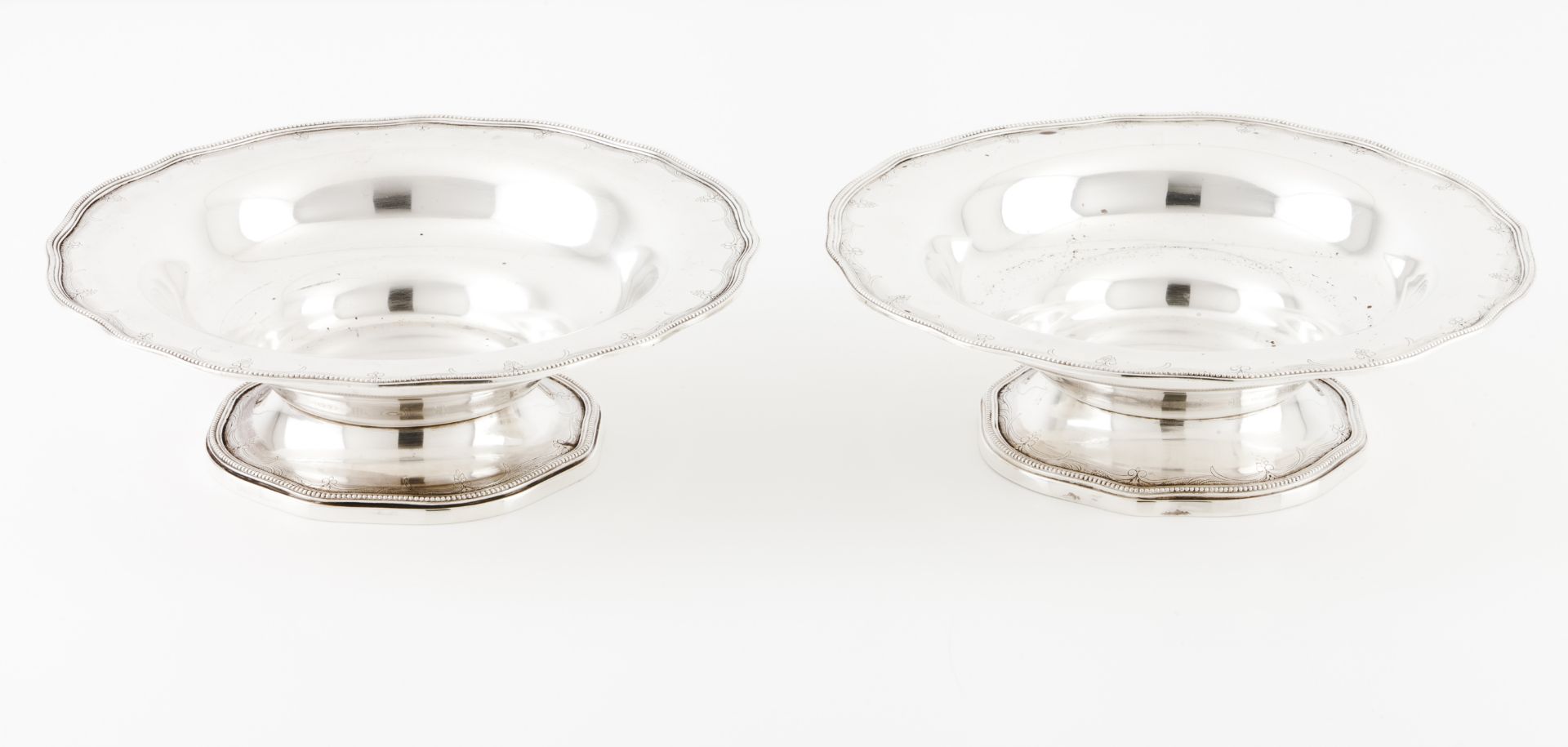 A pair of footed fruit bowlsPortuguese silver Plain body of scalloped lip with engraved foliage band