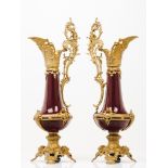 A pair of large jugsOx blood glazed porcelain of raised and gilt applied spelter elements with