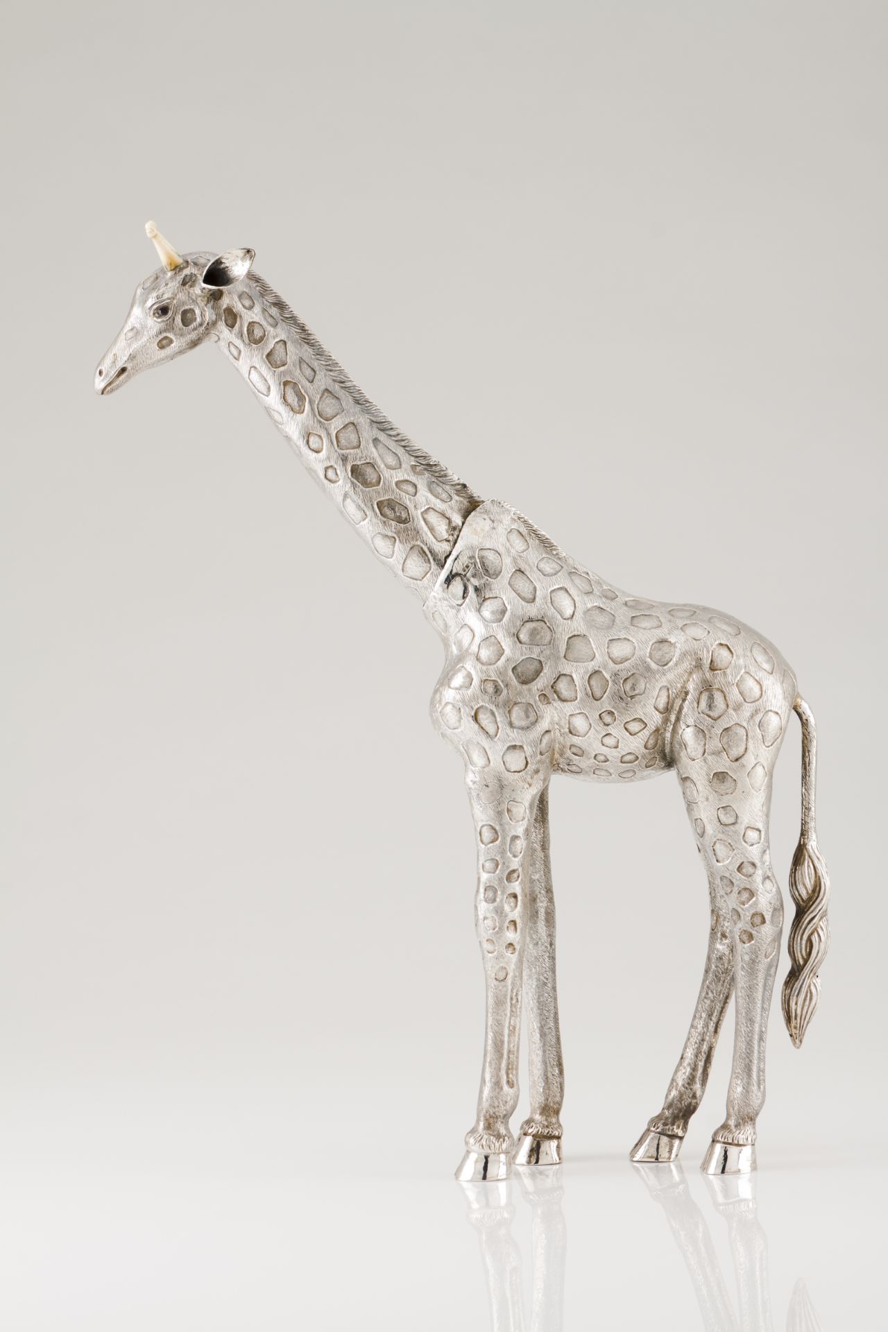 A Luiz Ferreira giraffeSilver and ivory Engraved and chiselled sculpture Oscillating neck and garnet