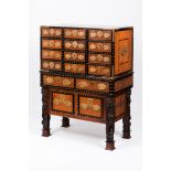 An Indo-Portuguese cabinetTeak, sissoo, ebony and ivory Upper section of nine drawers simulating