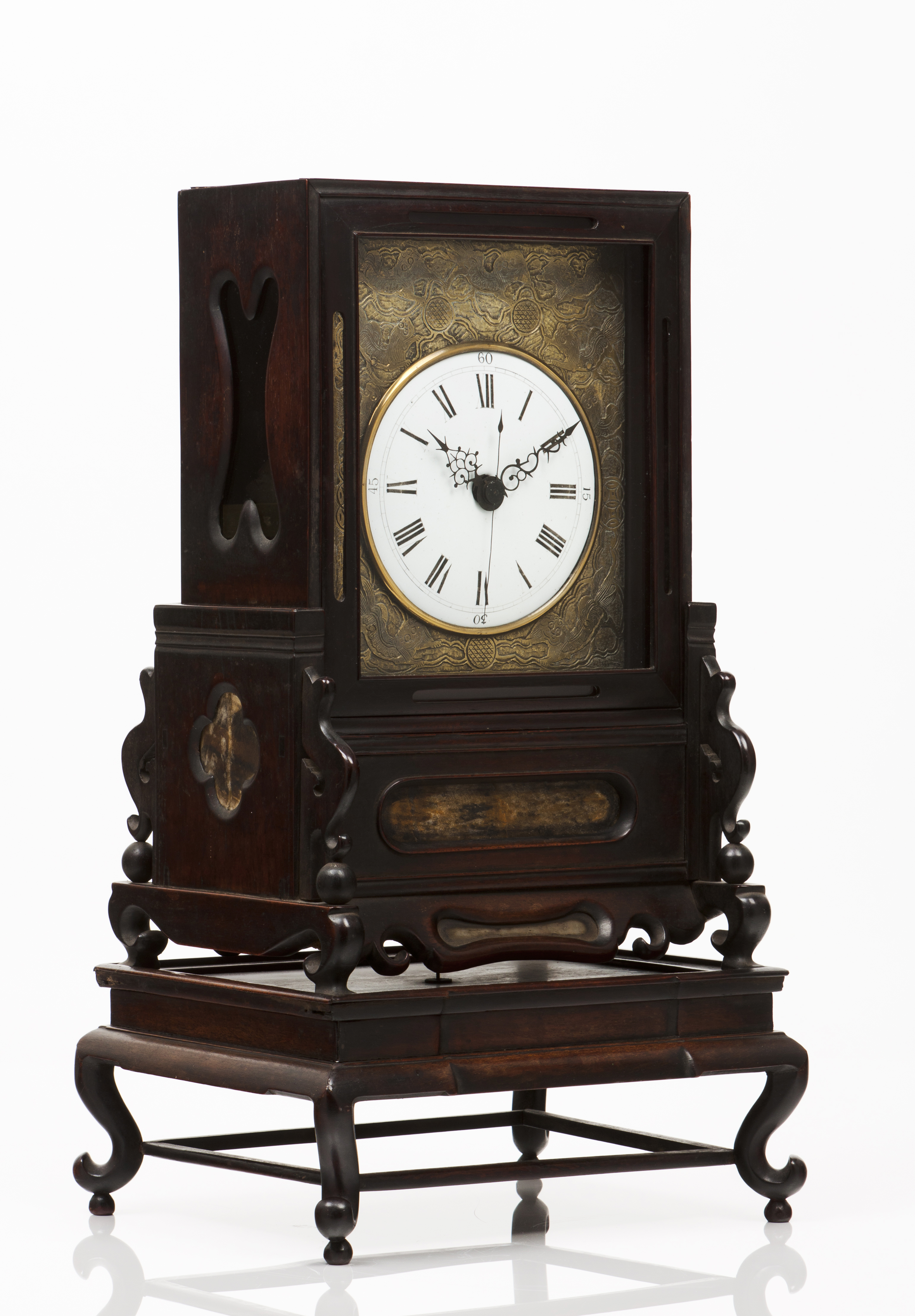 A table clockCarved wooden case Gilt metal front of relief decoration and enamelled dial China, 19th