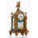 A table clockGilt, relief and chiselled bronze Caryatids, birds, garlands and other foliage and