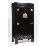 A large "moon face" cupboardLacquered wood Gilt metal hardware Carved and pierced apron depicting