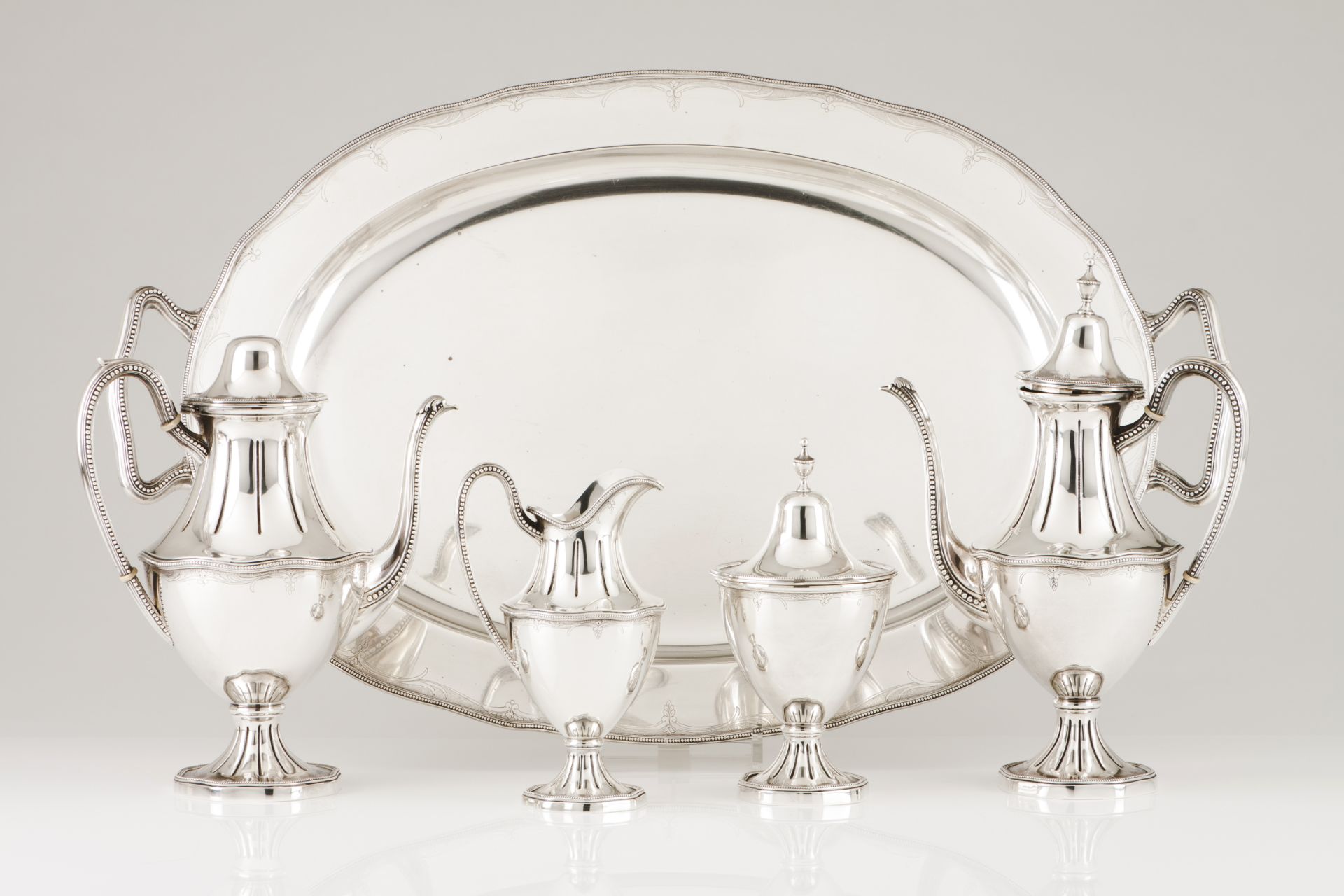 A tea and coffee set with trayPortuguese silver Plain body of engraved foliage band and beaded