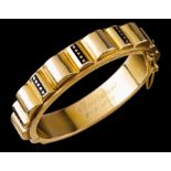 An Art Deco braceletPortuguese gold Hinged articulation, blue enamelled decorative elements with