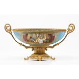 A bowl/centrepieceEuropean porcelain Decorated with domestic scenes and gilt cartouches on a blue