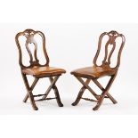 A set of four D.José style folding chairsWalnut Pierced and scalloped backs, carved decorated 20th