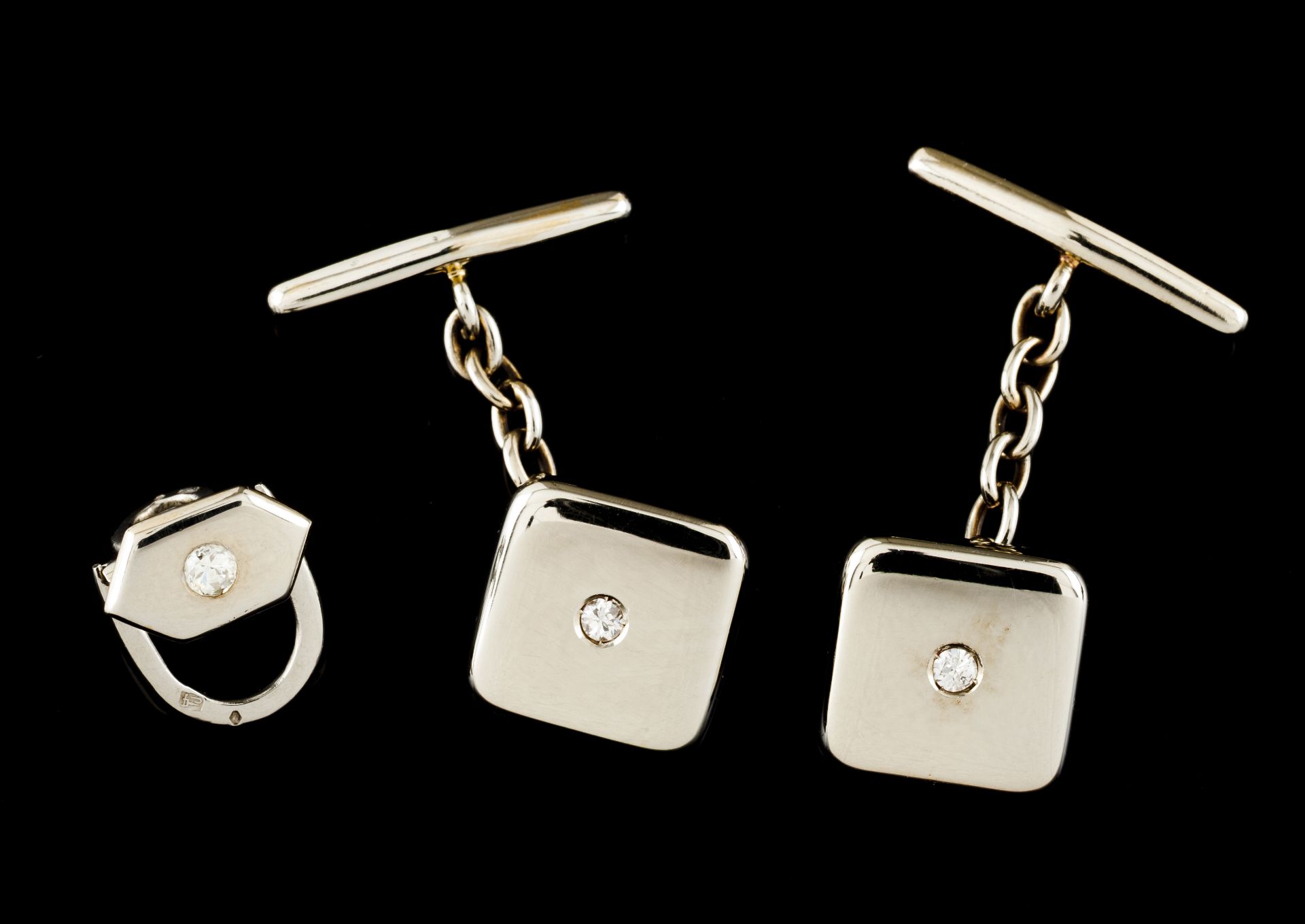 A pair of cufflinks and a studPortuguese gold Square shaped set with small brilliant cut diamond Ant