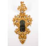 A wall mirrorCarved and gilt wood Foliage and angel's head decoration Spain, 19th century160x78 cm