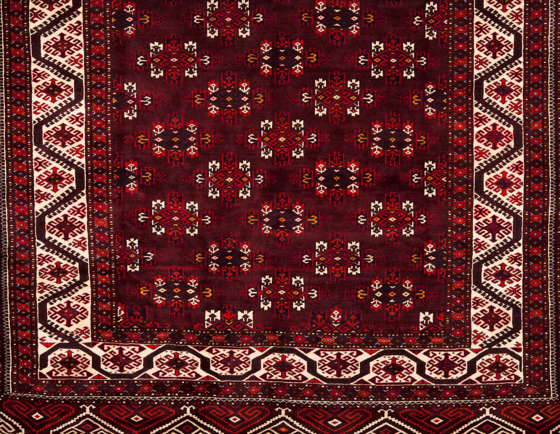 A Bukhara rug, IranWool and cotton Geometric pattern in bordeaux, beige and blue shades351x228 cm