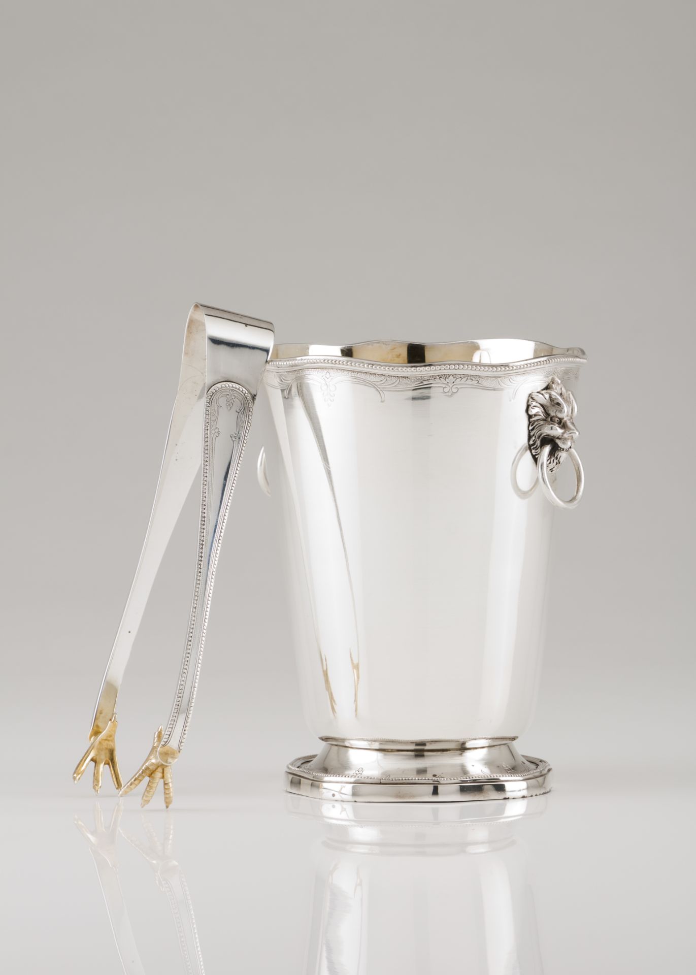 An ice bucket with tongs and gridPortuguese silver Plain body of foliage engraved band and beaded