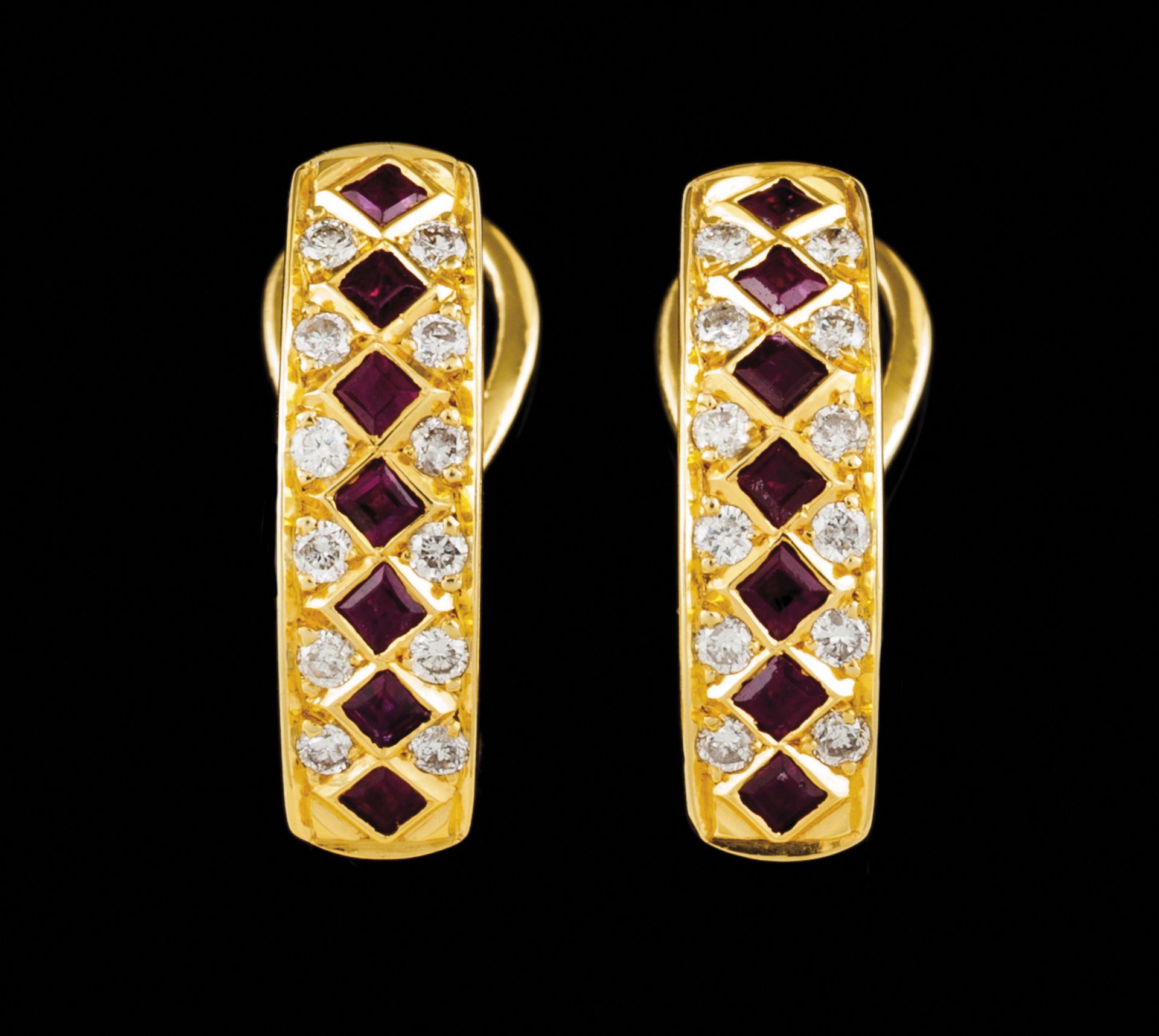 A pair of earringsPortuguese gold Set with a row of 7 calibrated rubies framed by 2 friezes of small