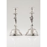A pair of candle standsPortuguese silver Medieval warrior shaped shaft wearing suit of armour and