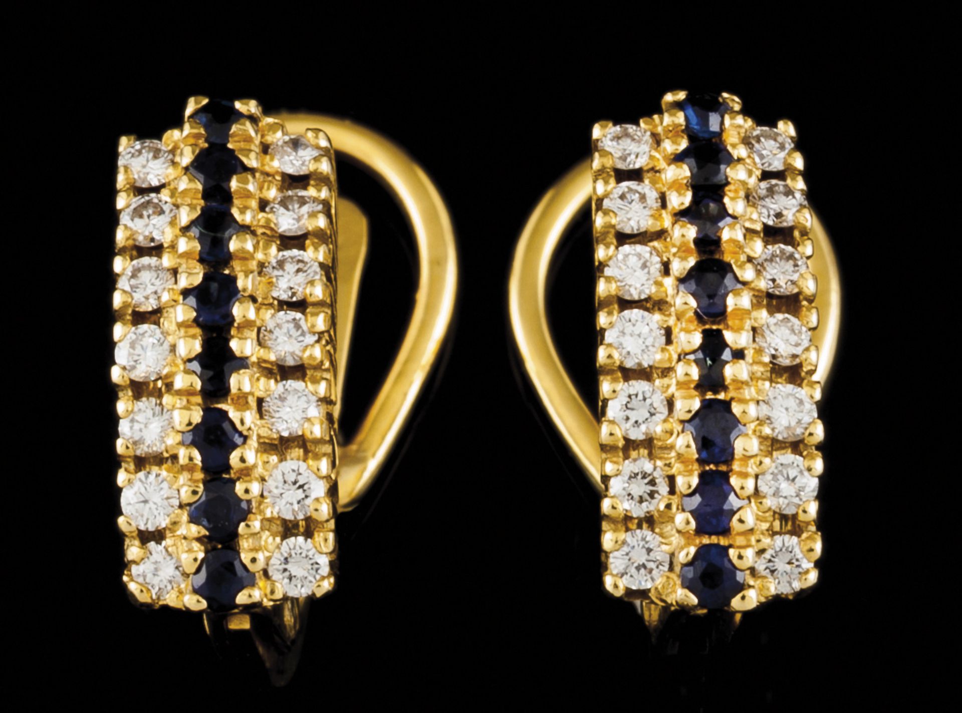 A pair of earringsPortuguese gold Set with a row of round cut sapphires framed by 2 friezes of small