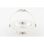 A fruit bowlPortuguese silver Plain scalloped stand Articulated interlaced handle Eagle hallmark