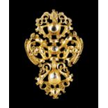 A bow pendantPortuguese gold, 19th century Articulated links of pierced foliage motifs decoration