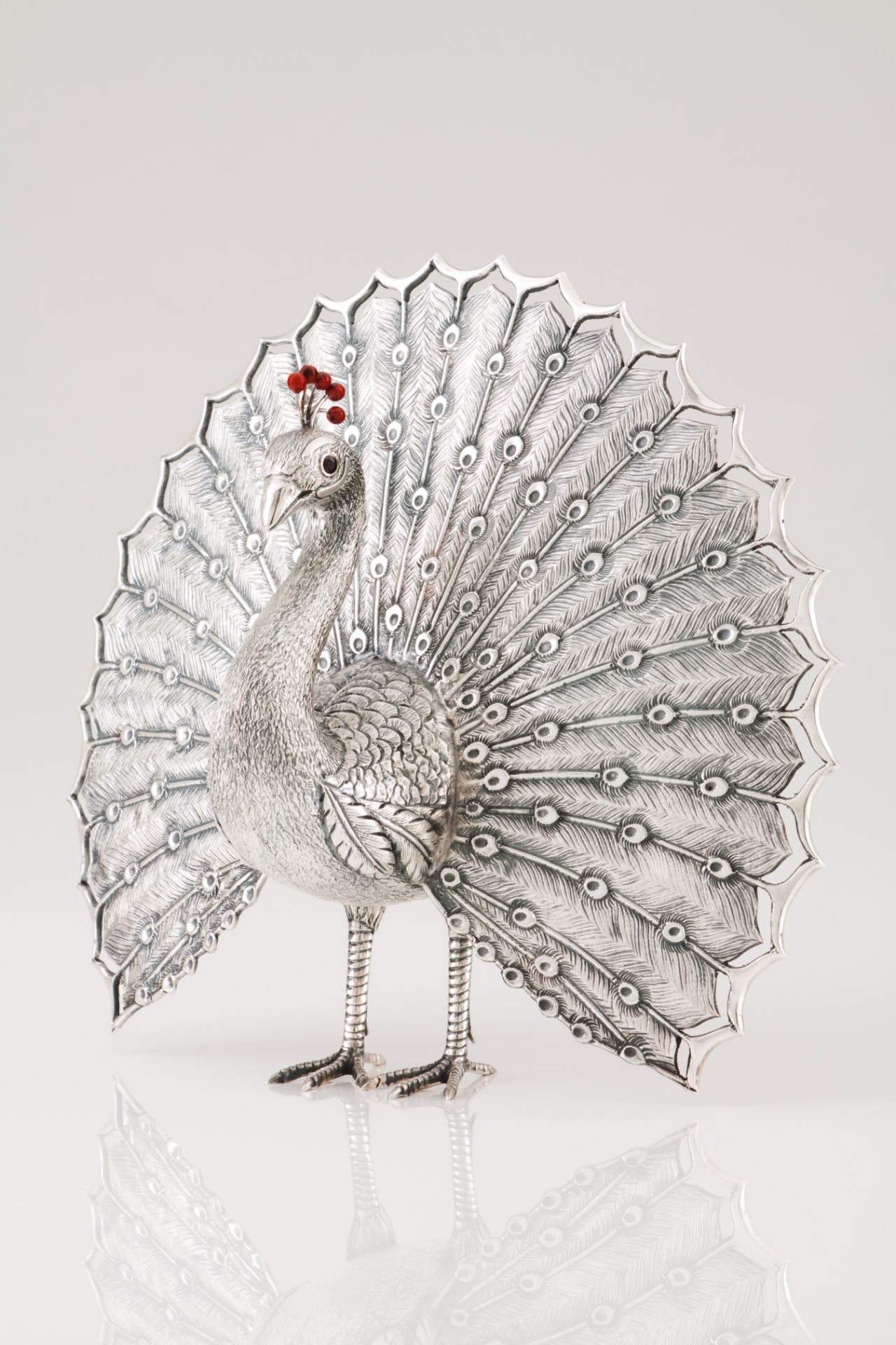 A peacockPortuguese silver and hardstone Moulded, engraved and chiselled decoration with applied red