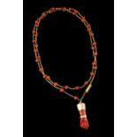 A chain with pendantGold Loops chain with applied coral beads and lucky charm pendant 19/20th