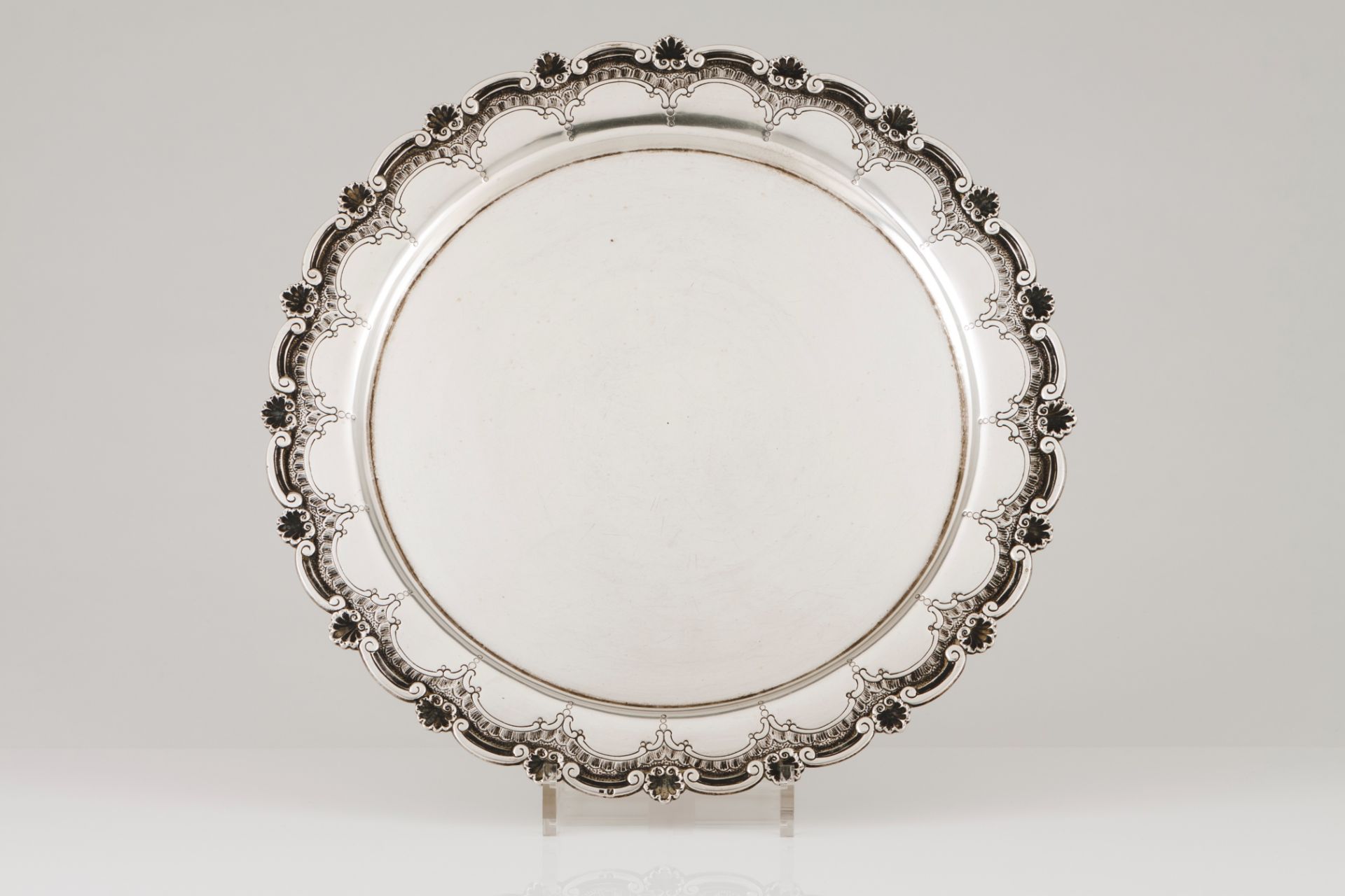 A salverPortuguese silver Plain centre, engraved lip and scalloped rim of applied winglet and