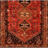 A Qashqai rugWool and cotton Geometric pattern of floral motifs and animals in brown, salmon,