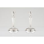 A pair of candle sticksSpanish silver, 20th century Fluted decoration Assay and same date maker's