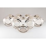 A set of twelve deep platesPortuguese silver Plain centre, lip of floral and foliage reliefs