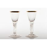A pair of footed drinking glassesGlass Gilt frieze to rim Spiralled decoration to shafts Europe,