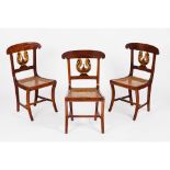 A set of three Empire chairsIn myrtle Carved, pierced and part gilt swan decoration to backs Caned