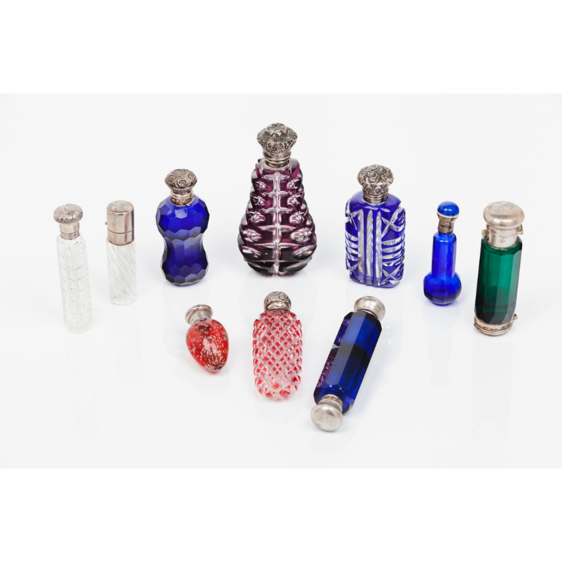 A set of ten perfumes bottles and stoppersGlass Various shapes and decorations Silver and silvered
