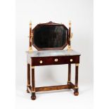 An Empire dressing table Solid and veneered mahogany Gilt bonze mounts Hexagonal tilting mirror