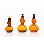 A group of three bottles with stoppersGourd-shaped amber glass Europe, 19th centuryHeight: 13,5 cm