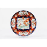 A plateJapanese porcelain Imari decoration of central landscape with animals and foliage motifs 19th