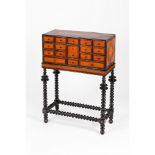 An Indo-Portuguese cabinet on standTeak and other timber Seventeen miscellaneous drawers of ebonised