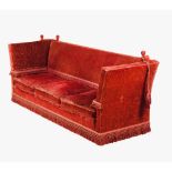 A Knole sofaRed velvet upholstery Drop arms and backs England, 20th century (signs of wear)