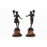 A pair of candlesticksSpelter Figures of Africans Stone stands (losses and faults)Height: 44 cm