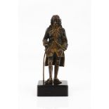 A figure attired in 18th century fashionPatinated bronze sculpture of gilt highlights Marble