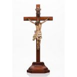 A crucified ChristCarved and polychrome wood Silver radiant halo and plaque unmarked in accordance