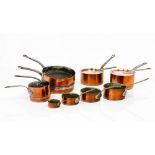 A group of twelve piecesSeven cooking pots, three frying pans and two lids Copper, pewter lined
