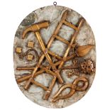 An oval medallionCarved, marbled and gilt wood depicting symbols of the Passion of Christ