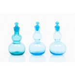 A group of three bottles and stoppersGourd-shaped blue glass Europe, 19th century (one faulty)