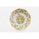 A plateFaience Blue, yellow, green, orange and manganese decoration with foliage motifs Portugal,