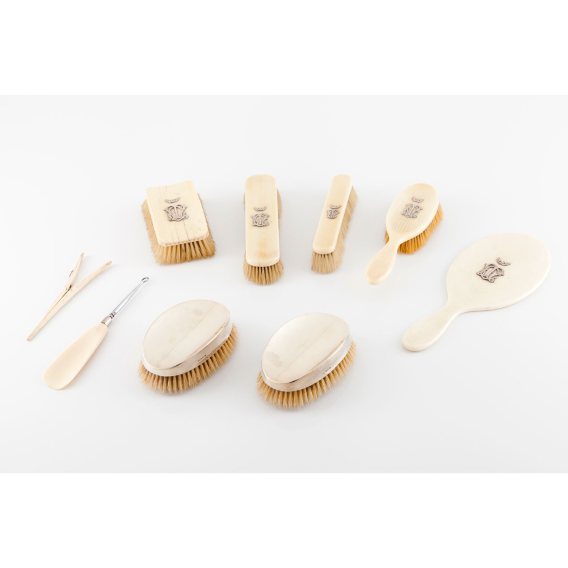 A dressing table set Six various brushes, one glove stretcher, hand mirror, button hook/shoe horn
