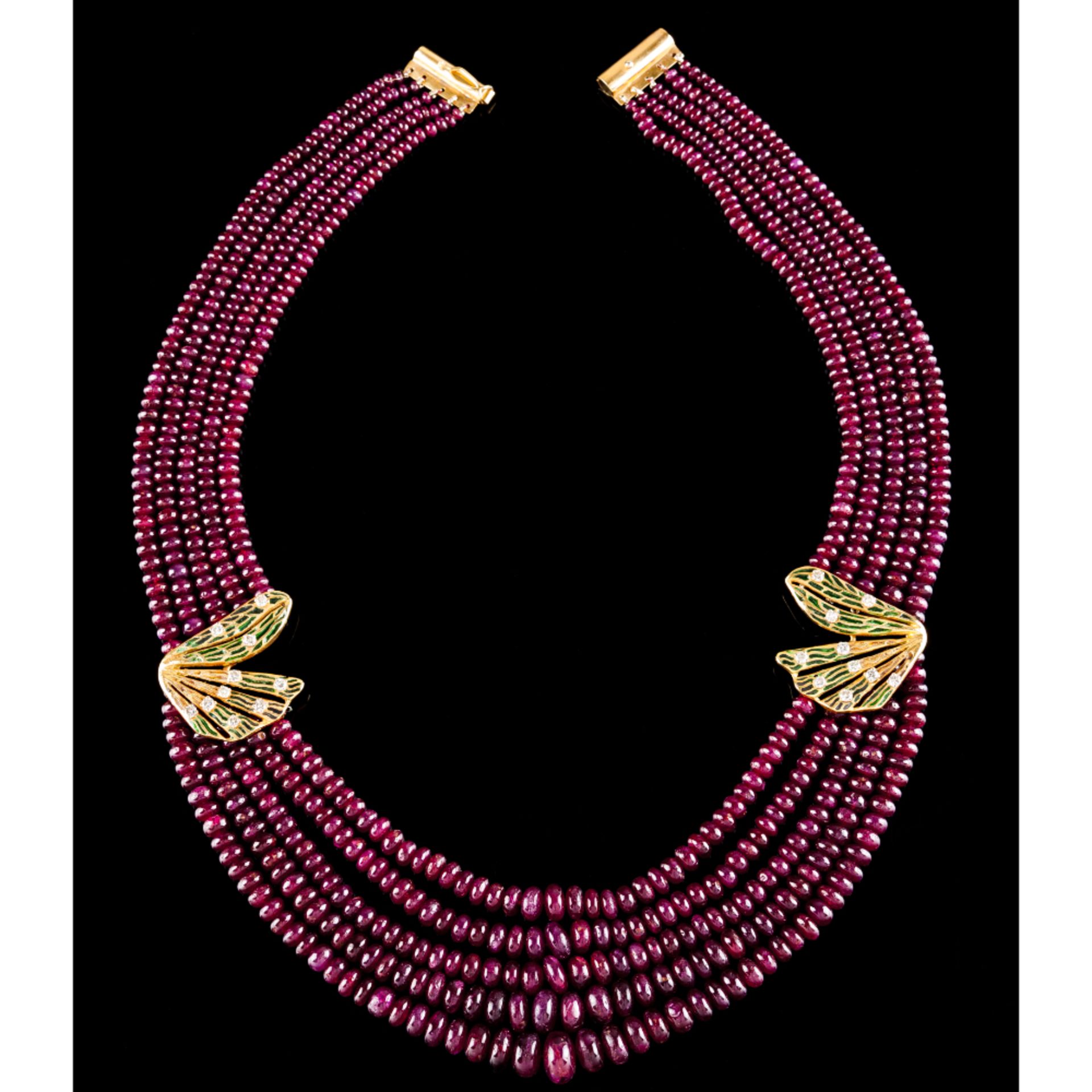 A five strand ruby beads necklaceGold clasp and applied elements Green enamel decoration and set