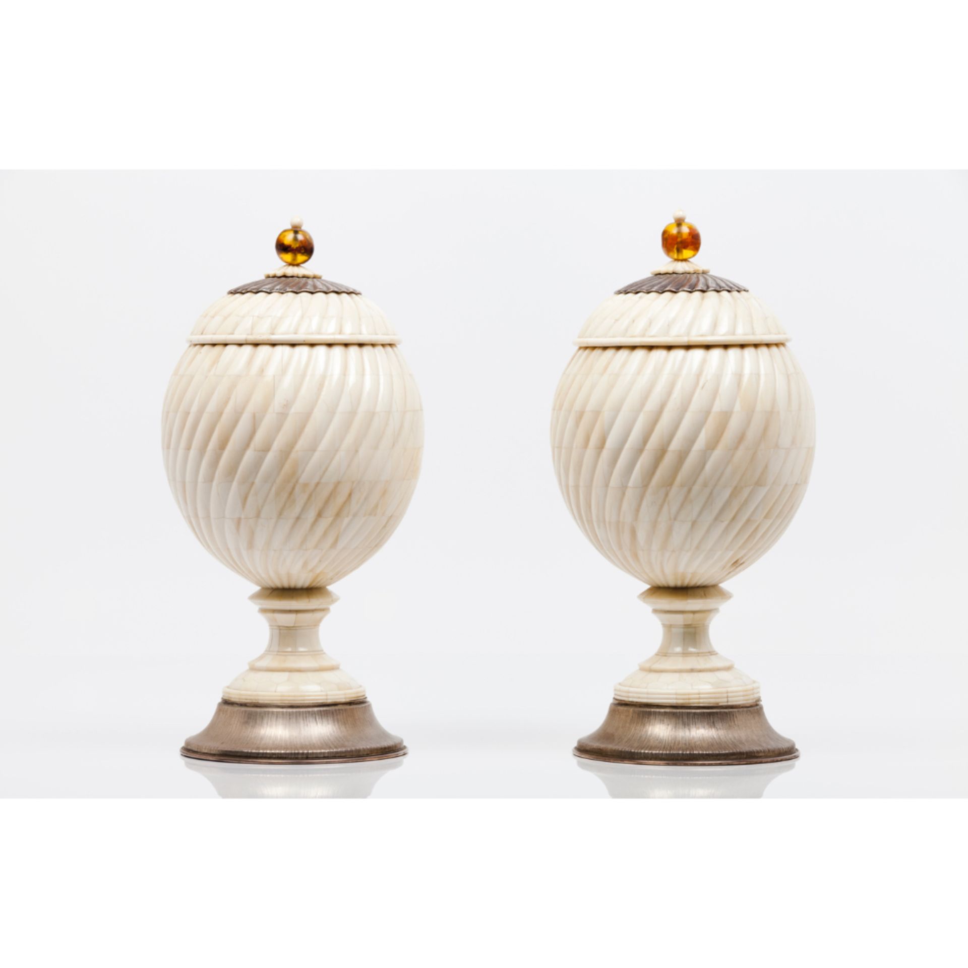 A pair of pots with coversWooden carcass coated in ivory with amber lid pommels Spiralled decoration